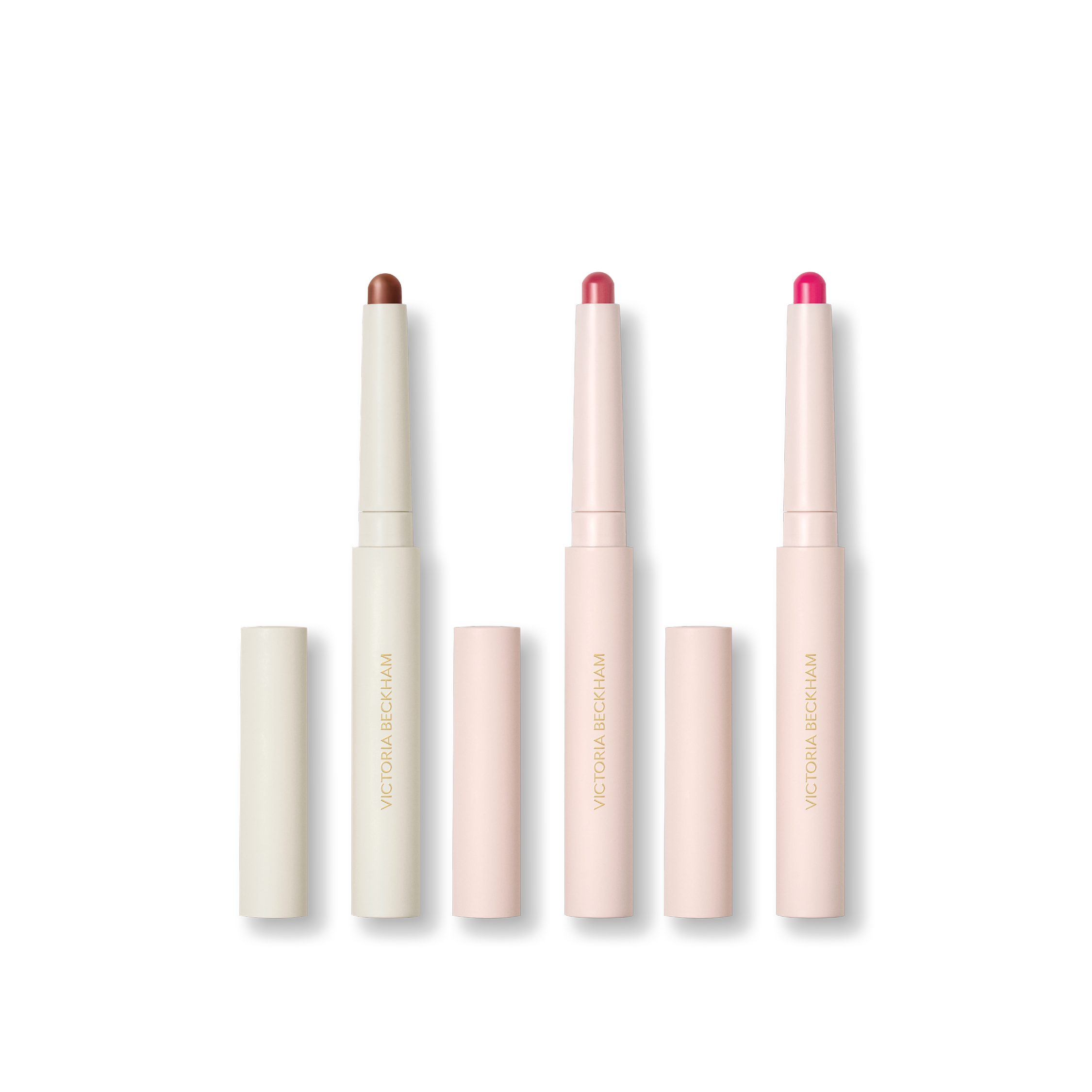 Three stylus pencils on black — Contour Stylus, Blush Stylus in Rossa and Blush Stylus in Fiore — Victoria Beckham Beauty.