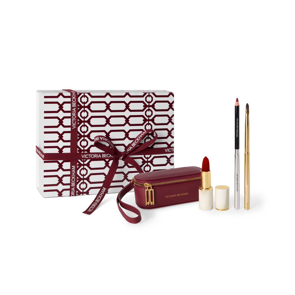 Victoria Rose makeup gift set featuring a white and burgundy patterned gift box with a matching ribbon, a burgundy zippered pouch, a lipstick, a lip pencil, and two gold-toned pens on a white background.