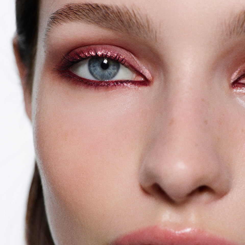 Front-facing close-up of rose-gold shimmer lids lined in burgundy — Victoria Beckham Beauty Bordeaux Eye Kit look.