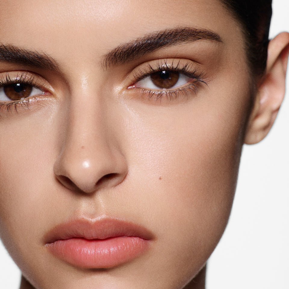 Close-up of a woman's face with a neutral background