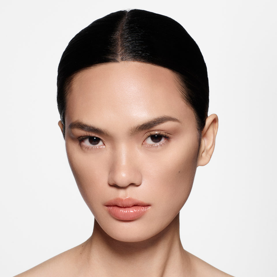 Close-up of a woman with a neutral expression on a white background