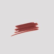 Swatch of Lip Definer No. 04 on grey backdrop — Victoria Beckham Beauty's brick red-brown lip pencil texture.