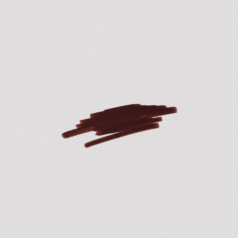 Swatch of Lip Definer No. 06 on grey backdrop — Victoria Beckham Beauty's deep espresso lip pencil texture.