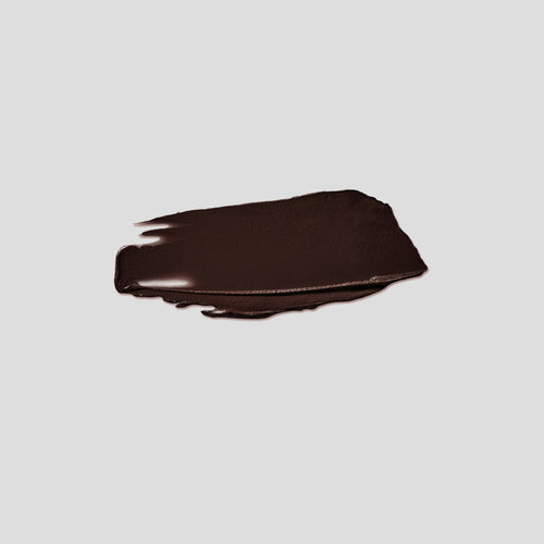 Brushstroke swatch of Contour Stylus Granite on grey backdrop — Victoria Beckham Beauty cool deep brown contour stick.