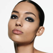 Model wearing Victoria Beckham Beauty Eye Wardrobe in Navy Noir – a bold, smoky eyeshadow look featuring deep navy, soft blue, and shimmering silver tones for a modern, statement finish.