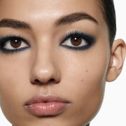 Close-up model shot wearing Victoria Beckham Beauty Eye Wardrobe in Navy Noir – a bold, smoky eyeshadow look featuring deep navy, soft blue, and shimmering silver tones for a striking, modern finish.