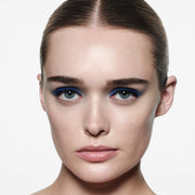 Model wearing Victoria Beckham Beauty Eye Wardrobe in Navy Noir – a bold, modern eyeshadow look featuring vibrant cobalt blue, deep navy, and soft blue tones for a striking, high-fashion finish.