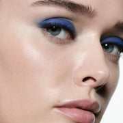 Close-up model shot wearing Victoria Beckham Beauty Eye Wardrobe in Navy Noir – a striking eyeshadow look featuring vibrant cobalt blue and deep navy tones for a bold, modern finish.