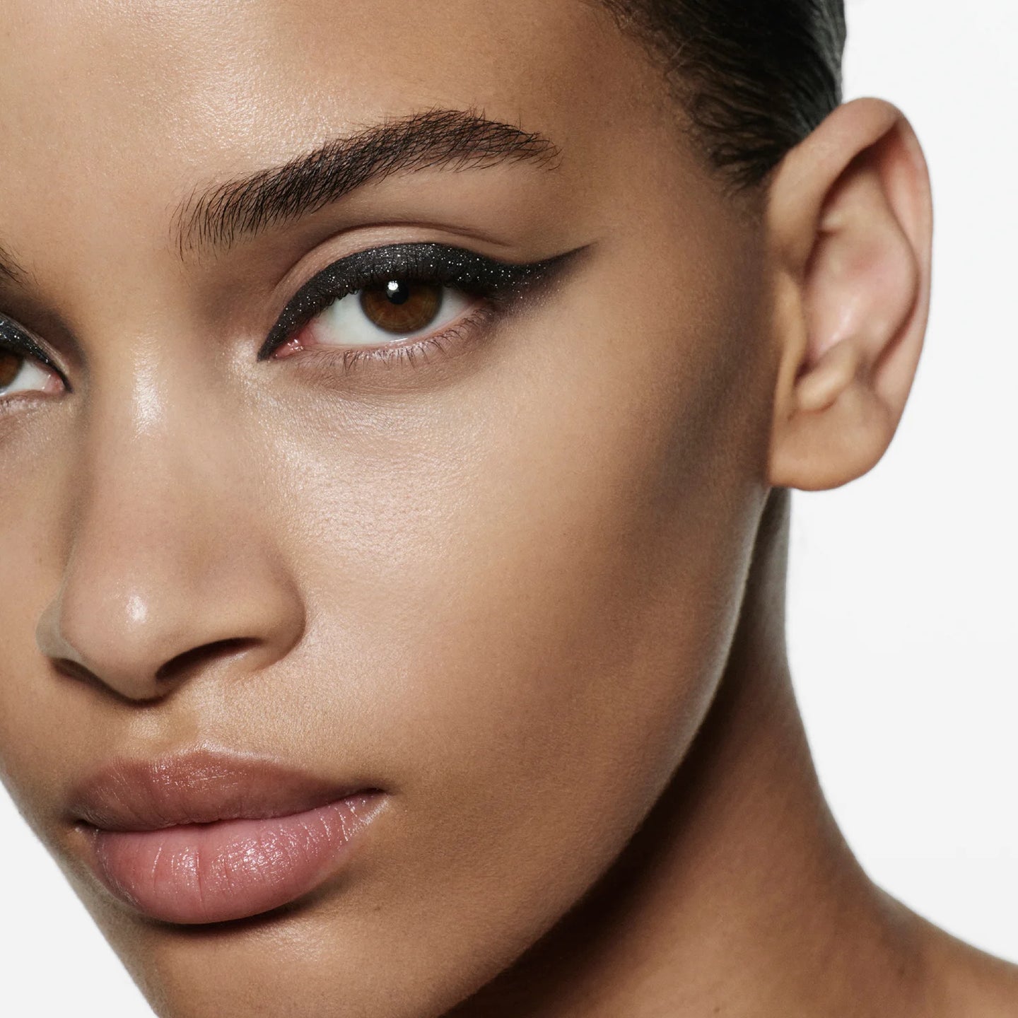 Close-up model shot wearing Victoria Beckham Beauty Eye Wardrobe in Night Flash – a bold, smoky eyeshadow look featuring deep black, shimmering taupe, and soft ivory tones for a dramatic, modern finish.