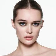 Model wearing Victoria Beckham Beauty Eye Wardrobe in Olive – a bold, smoky eyeshadow look featuring rich green, gold, and bronze tones for a modern, sophisticated finish.