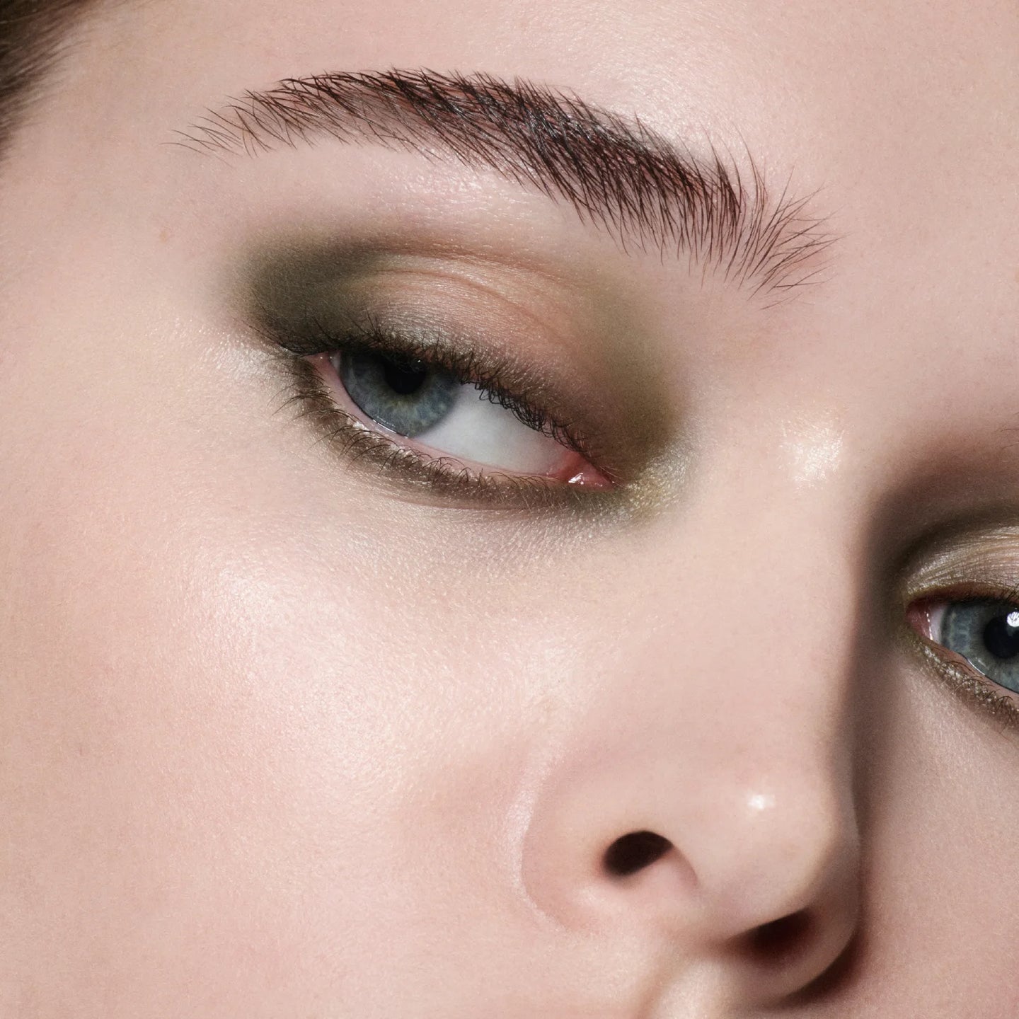 Close-up model shot wearing Victoria Beckham Beauty Eye Wardrobe in Olive – a sultry, smoky eyeshadow look with rich green, bronze, and gold tones for a modern, luxurious finish.