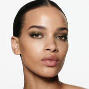 Model wearing Victoria Beckham Beauty Eye Wardrobe in Olive – a luxurious eyeshadow look featuring rich green and gold tones for a smoky, sophisticated finish.