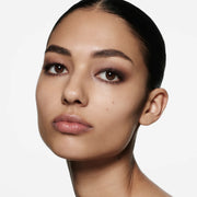 Model wearing Victoria Beckham Beauty Eye Wardrobe in Victoria – a versatile eyeshadow palette with warm brown, shimmering bronze, and deep espresso tones, creating a soft, smoky eye look with effortless elegance.