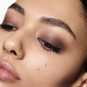 Close-up model shot featuring Victoria Beckham Beauty Eye Wardrobe in Victoria – a luxe eyeshadow palette with warm brown and deep espresso tones, blended seamlessly for a soft, smoky eye look with a sophisticated finish.