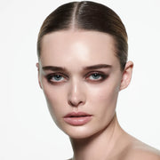 Model wearing Victoria Beckham Beauty Eye Wardrobe in Victoria – a refined, smoky eyeshadow look featuring warm beige, rich brown, deep espresso, and shimmering bronze tones for an effortlessly chic finish.