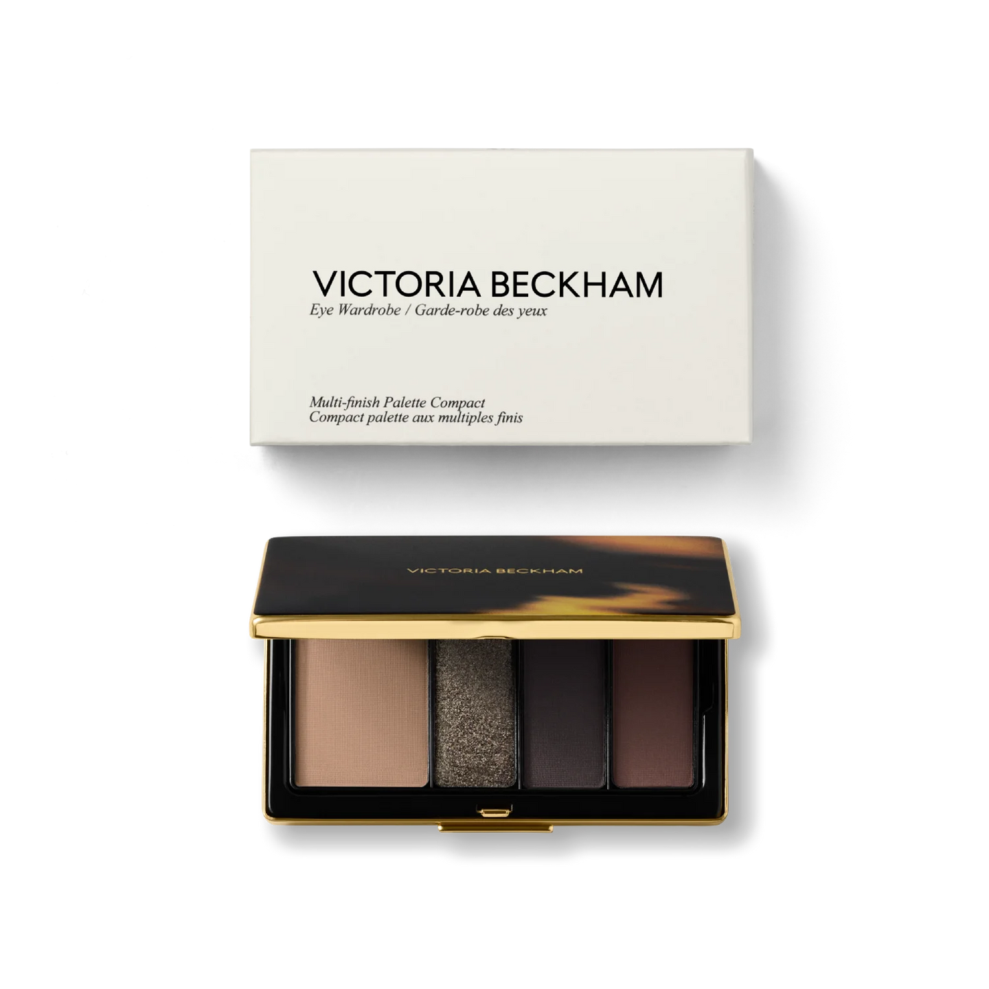 Product shot of Victoria Beckham Beauty Eye Wardrobe in Victoria – a luxury eyeshadow palette featuring rich neutral and deep brown tones with a mix of matte and shimmering finishes, housed in an elegant gold-trimmed compact with packaging.