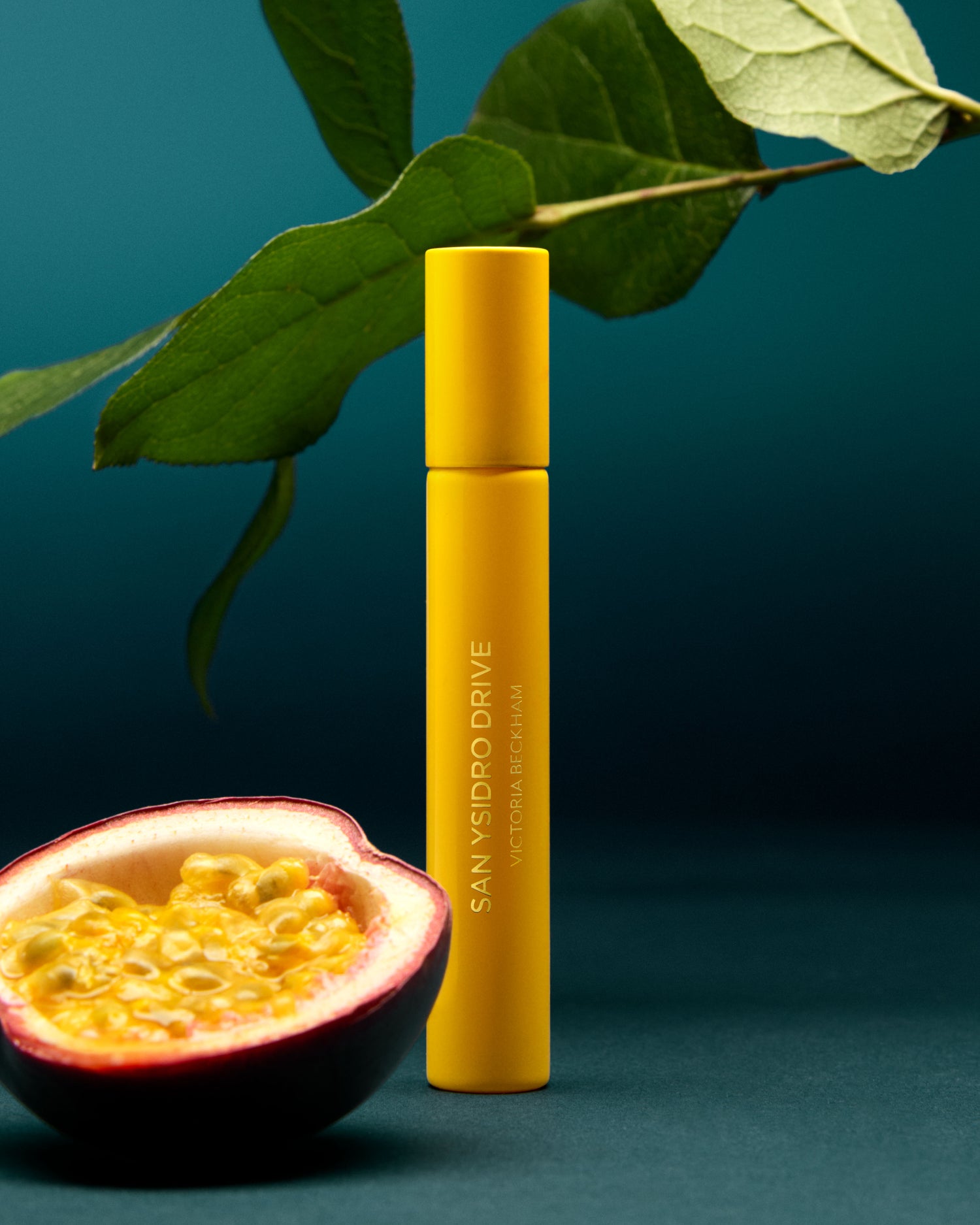 Yellow bottle with 'SAN YSIDR$O DRIVE' branding next to a halved passion fruit on a teal background