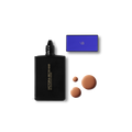 Black foundation bottle with dropper, blue box, and three tan-colored foundation drops displayed beside it.
