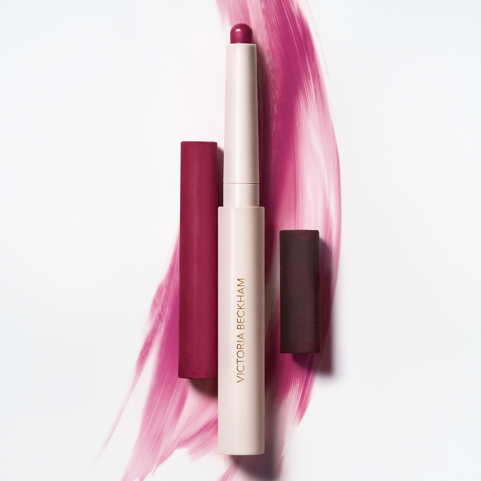 Blush Stylus in Rubino on a deep magenta brushstroke — Victoria Beckham Beauty's creamy blush stick in wine burgundy.