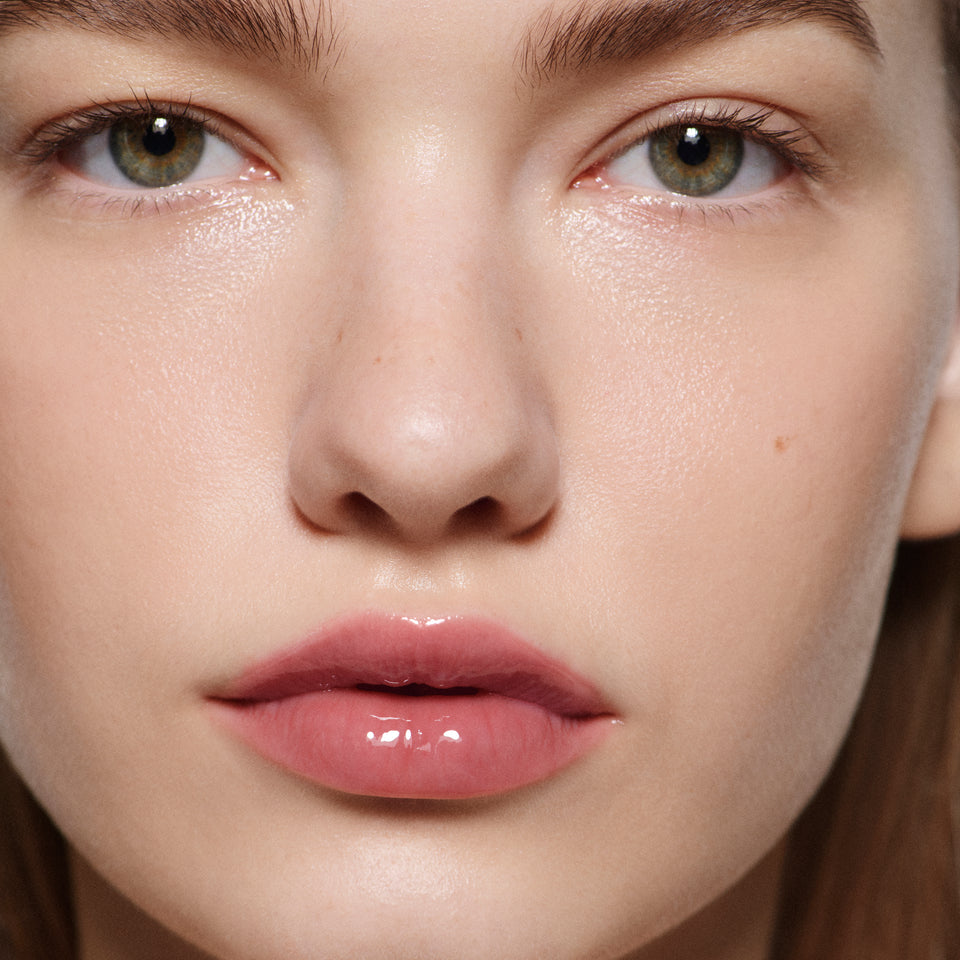 Close-up of fair lips in Posh Gloss Cabana — Victoria Beckham Beauty's dusty rose pink high-shine lip gloss.