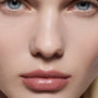 Close-up of fair lips wearing a soft rose nude Posh Lip — Victoria Beckham Beauty lipstick with a satin sheen.