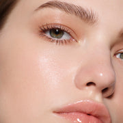 Close-up of a fair-complexion green eye with cocoa-brown lashes in Vast Lash Cocoa — Victoria Beckham Beauty.