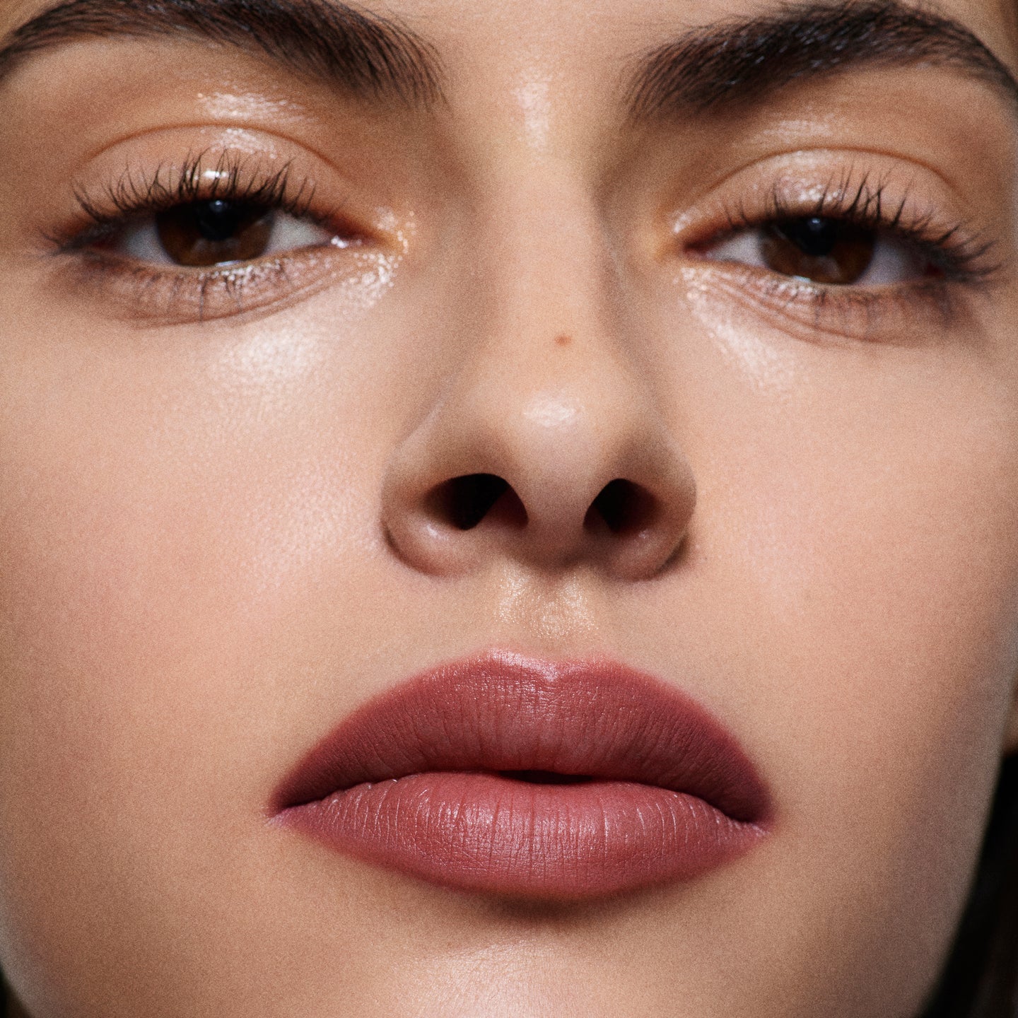 Close-up of olive-toned lips lined in Lip Definer No. 03 — Victoria Beckham Beauty's berry pink-rose lip pencil.