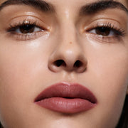Close-up of olive-toned lips lined in Lip Definer No. 03 — Victoria Beckham Beauty's berry pink-rose lip pencil.