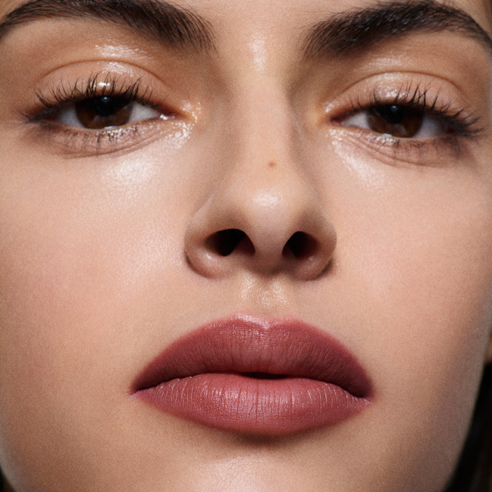 Close-up of olive-toned lips lined in Lip Definer No. 03 — Victoria Beckham Beauty's berry pink-rose lip pencil.