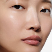 Close-up of tan lips lined in Lip Definer No. 01 — Victoria Beckham Beauty's dusty peach-rose lip pencil.