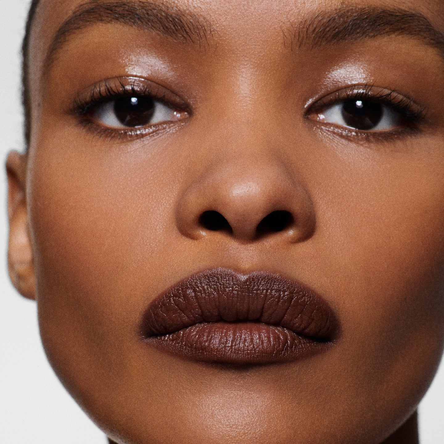 Close-up of deep-complexion lips lined in Lip Definer No. 06 — Victoria Beckham Beauty's deep espresso lip pencil.