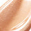Posh Gloss Martini swatch — Victoria Beckham Beauty's champagne gold shimmer lip gloss, cropped close-up. swatch