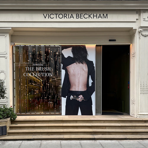 Victoria Beckham store front with a large poster of a person in a suit.