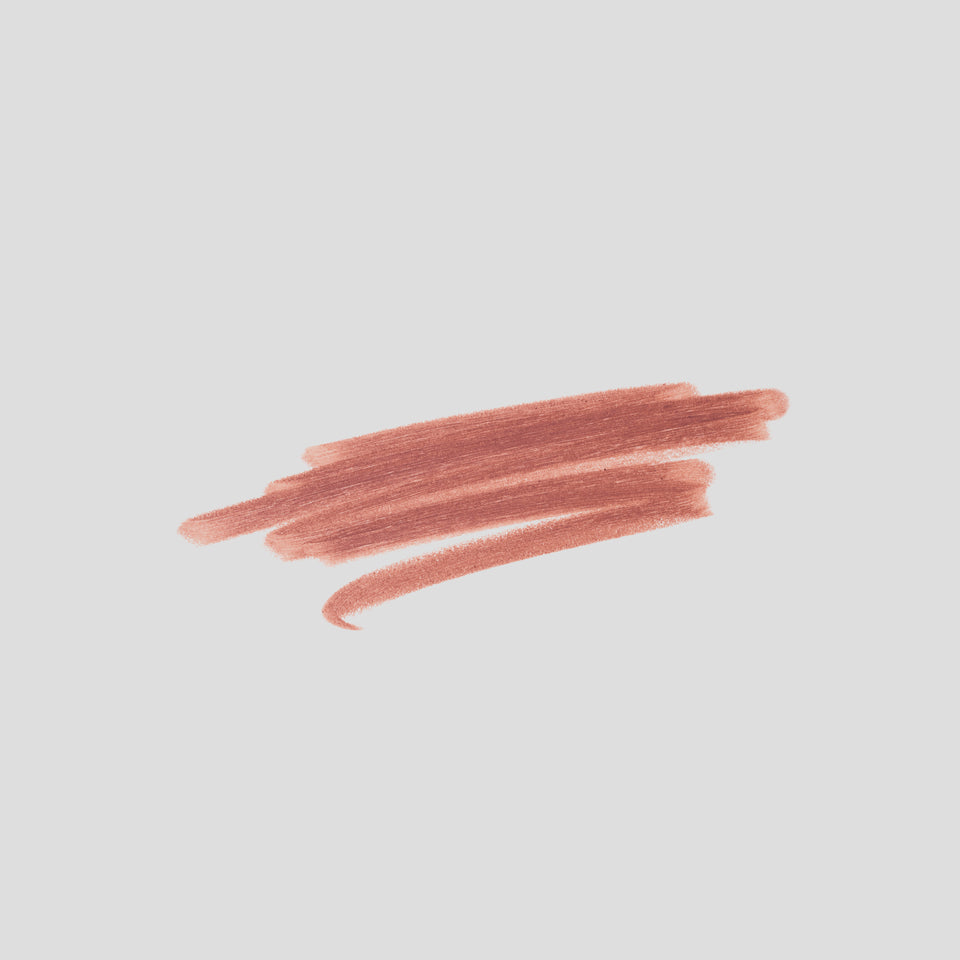 Swatch of Lip Definer No. 1.5 on grey backdrop — Victoria Beckham Beauty's warm rosy-taupe lip pencil texture.