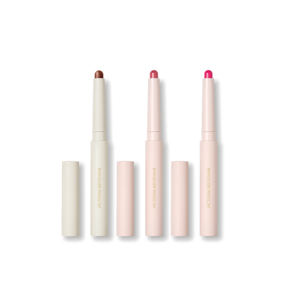 Three stylus pencils on black — Contour Stylus, Blush Stylus in Rossa and Blush Stylus in Fiore — Victoria Beckham Beauty.