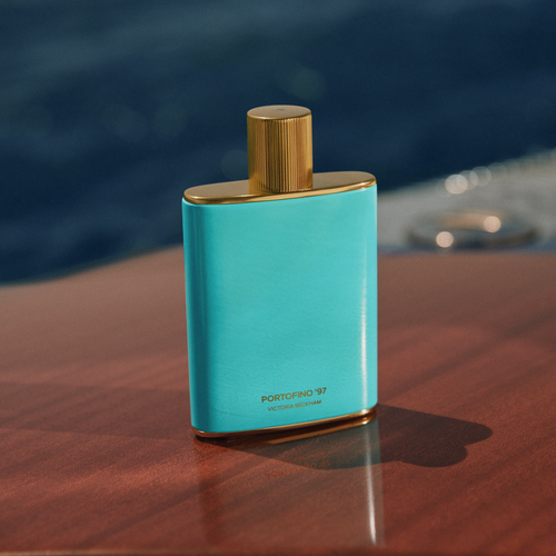 Turquoise, gold-capped Portofino '97 bottle stands on polished teak decking by Victoria Beckham Beauty.