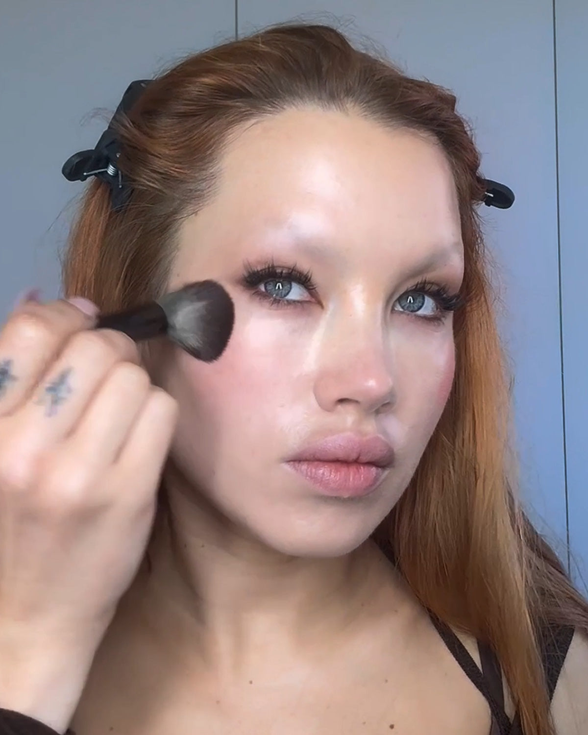 Isamaya Ffrench applying blush with a sculpt and blend brush.