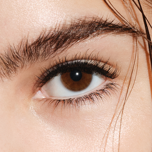 Close up image of a model's open eye, with mascara on their lashes.