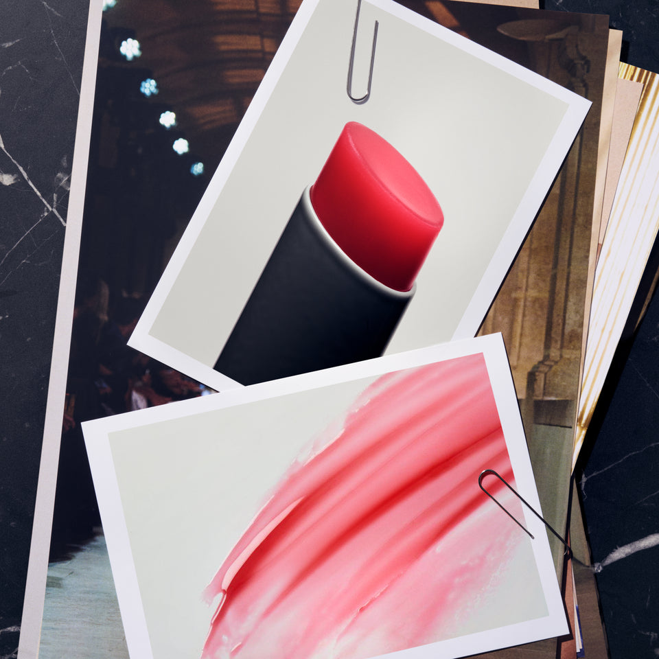 Victoria Beckham Beauty Posh Balm bullet and texture smear pinned photo-style over a runway backdrop collage.