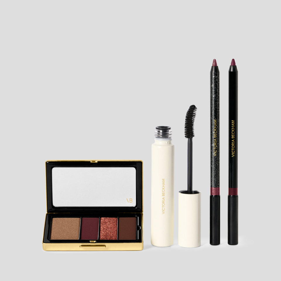 Bordeaux Eye Kit laid out: bronze, burgundy and copper eyeshadow quad, mascara and two pencils — Victoria Beckham Beauty.