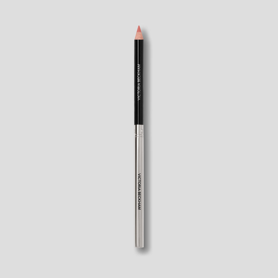 Victoria Beckham Beauty Lip Definer pencil in No. 01 — black barrel and silver base tipped in dusty peach-rose.