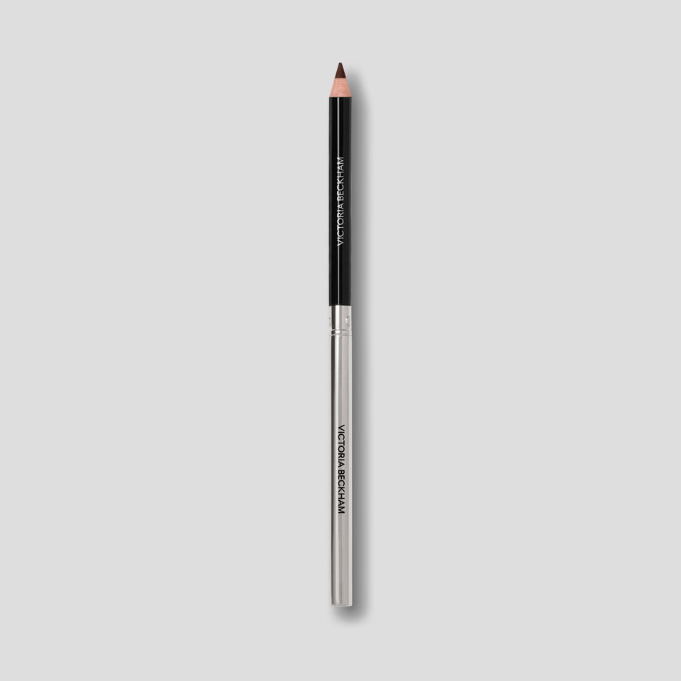 Victoria Beckham Beauty Lip Definer pencil in No. 06 — black barrel and silver base tipped in deep espresso.