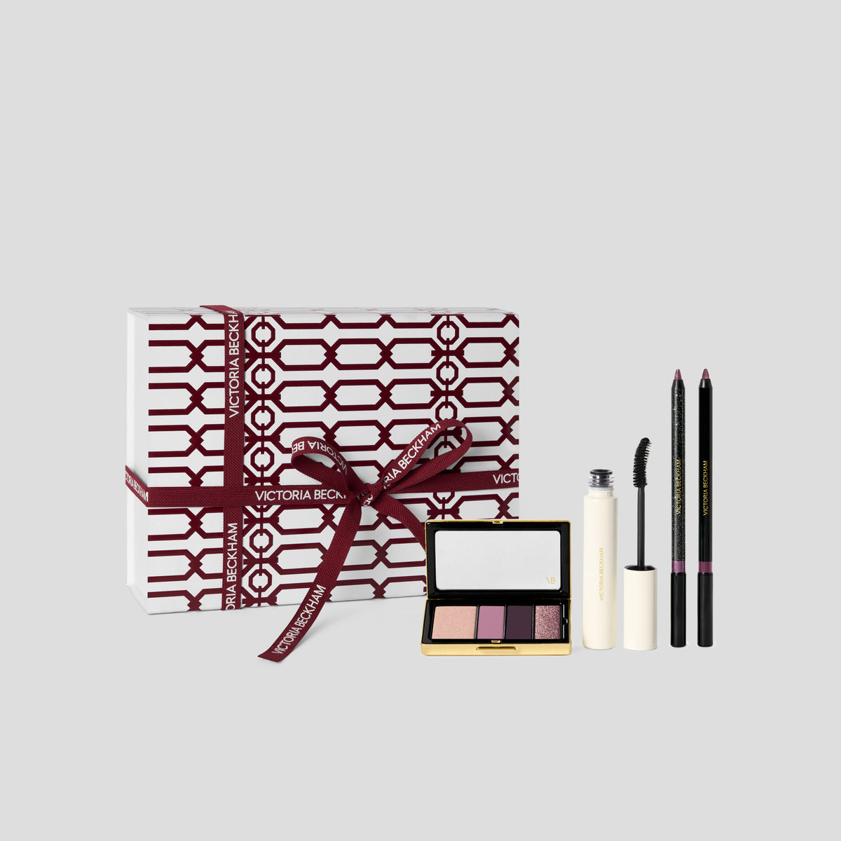 Orchid Eye Kit gift box in burgundy trellis print with a pink and plum eyeshadow quad, mascara and pencils — Victoria Beckham Beauty.