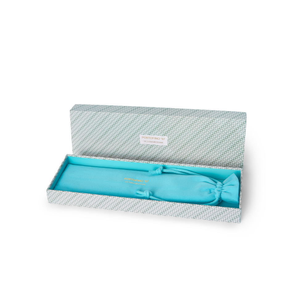 Open Portofino '97 gift box reveals a turquoise drawstring pouch nestled in matching satin lining.