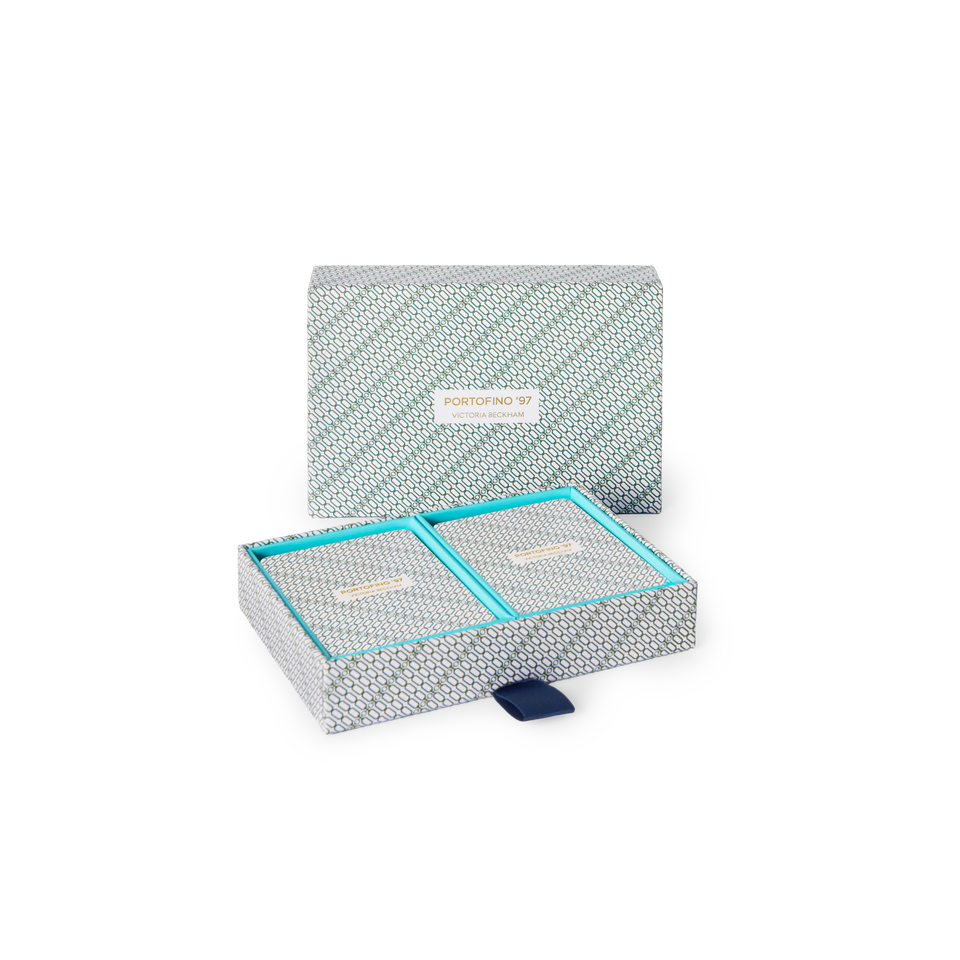 Open Portofino '97 playing card box shows two decks in turquoise-lined compartments, navy pull-tab at front.