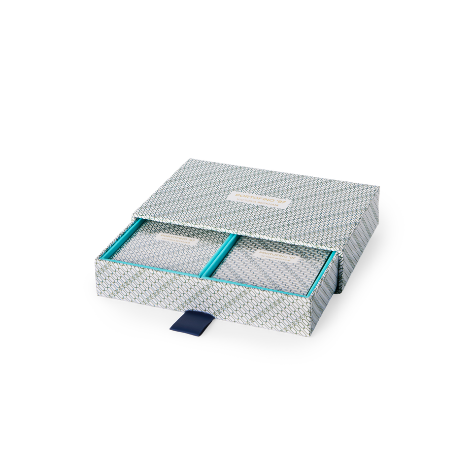 Overhead view of the open Portofino '97 playing card box, two decks in turquoise-lined compartments.