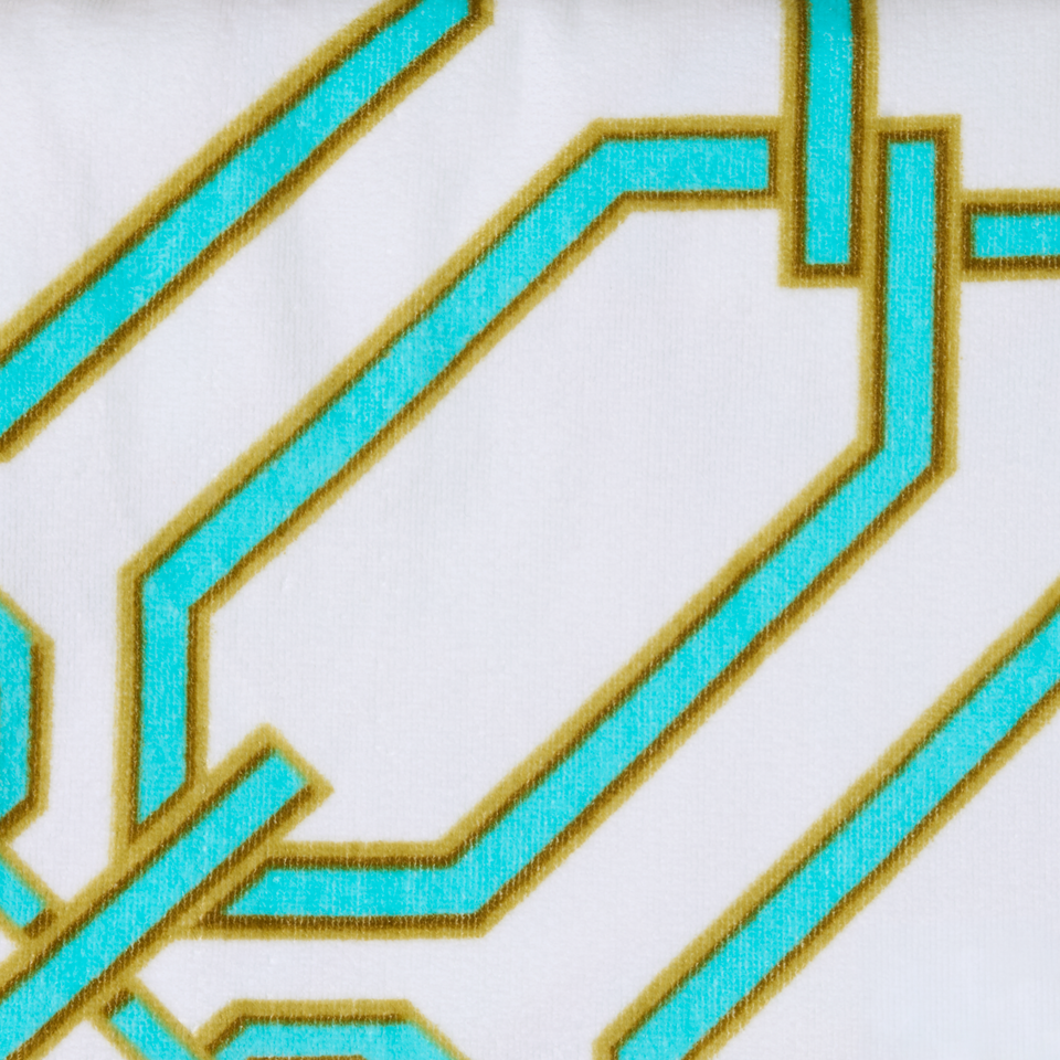 Macro of the Portofino '97 towel's terry weave in turquoise and gold chain-link print by Victoria Beckham Beauty.