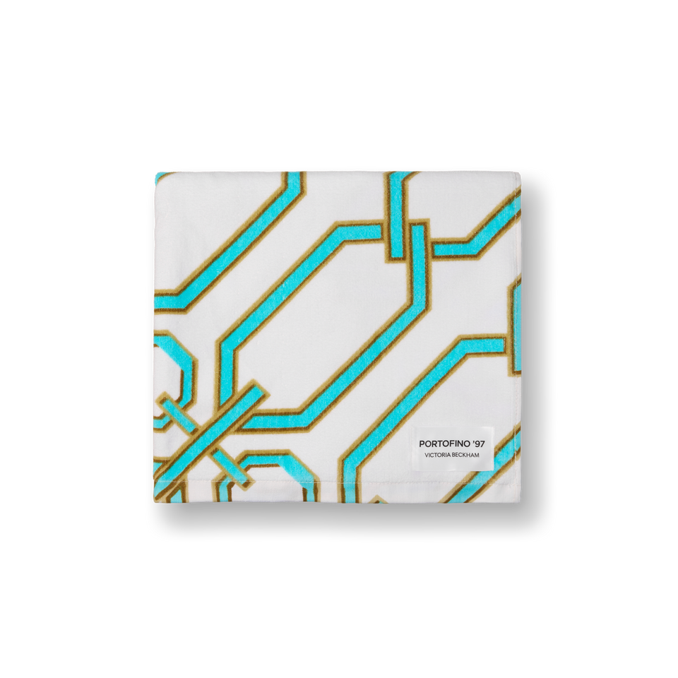 Folded Portofino '97 beach towel in turquoise and gold chain-link print, by Victoria Beckham Beauty.