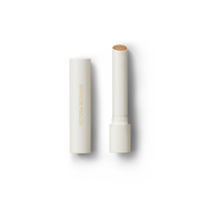 Open Victoria Beckham Beauty Posh Balm in Soleil — cream tube and cap beside the golden bronze shimmer balm bullet.
