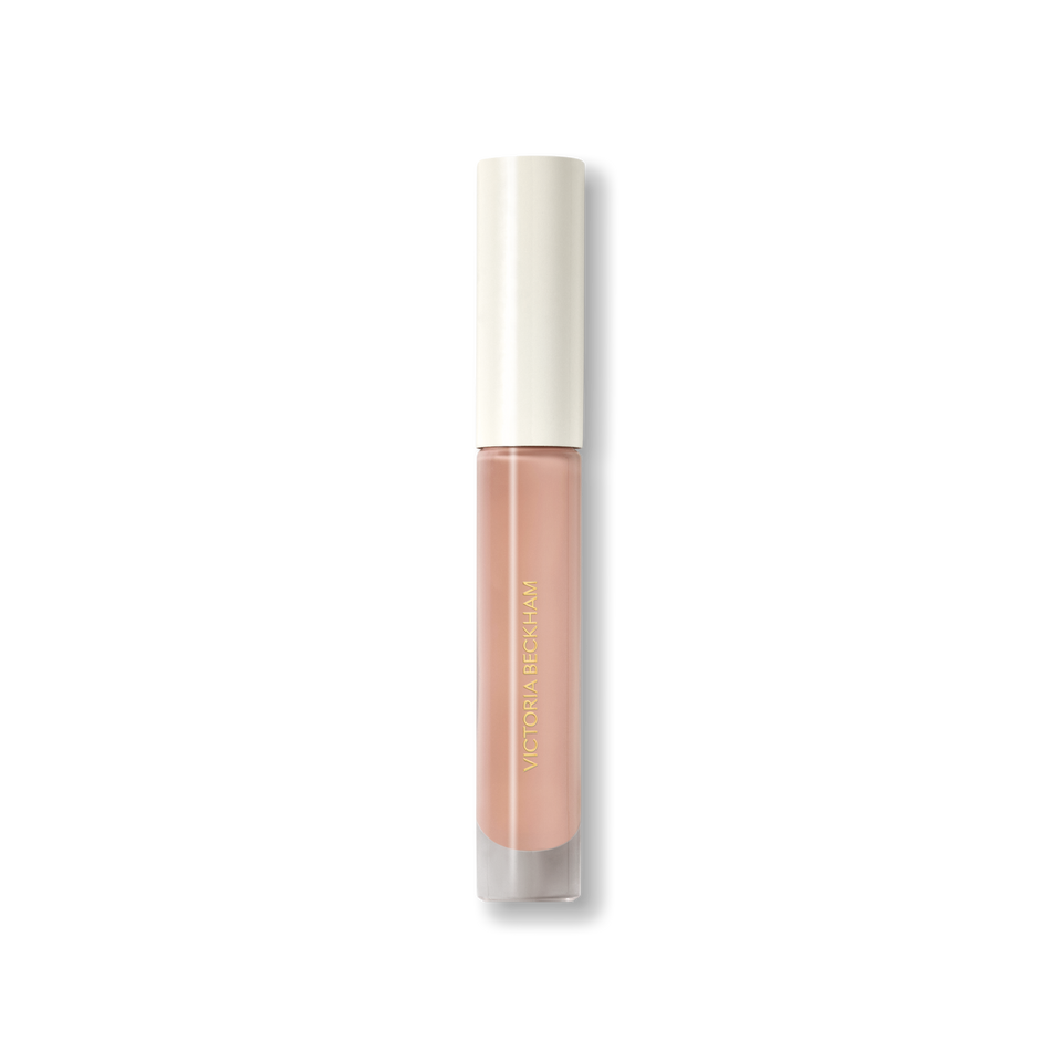 Closed Victoria Beckham Beauty Posh Gloss tube in Bikini — cream cap on a milky peach nude high-shine lip gloss.